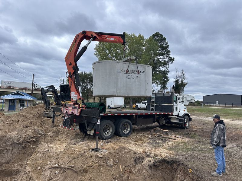 Concrete treatment tank arriving by crane truck
